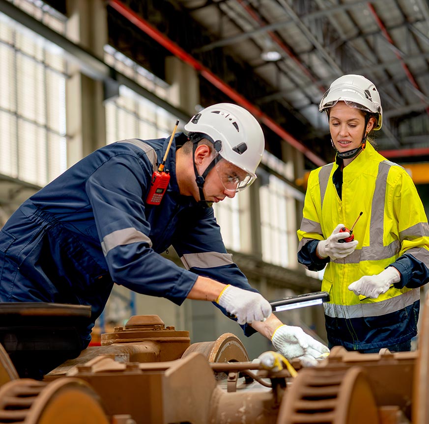 Professional technician or engineer try to check and fix the problem part of electric train and work with factory worker use walkie talkie to contact co-worker team in workplace area.